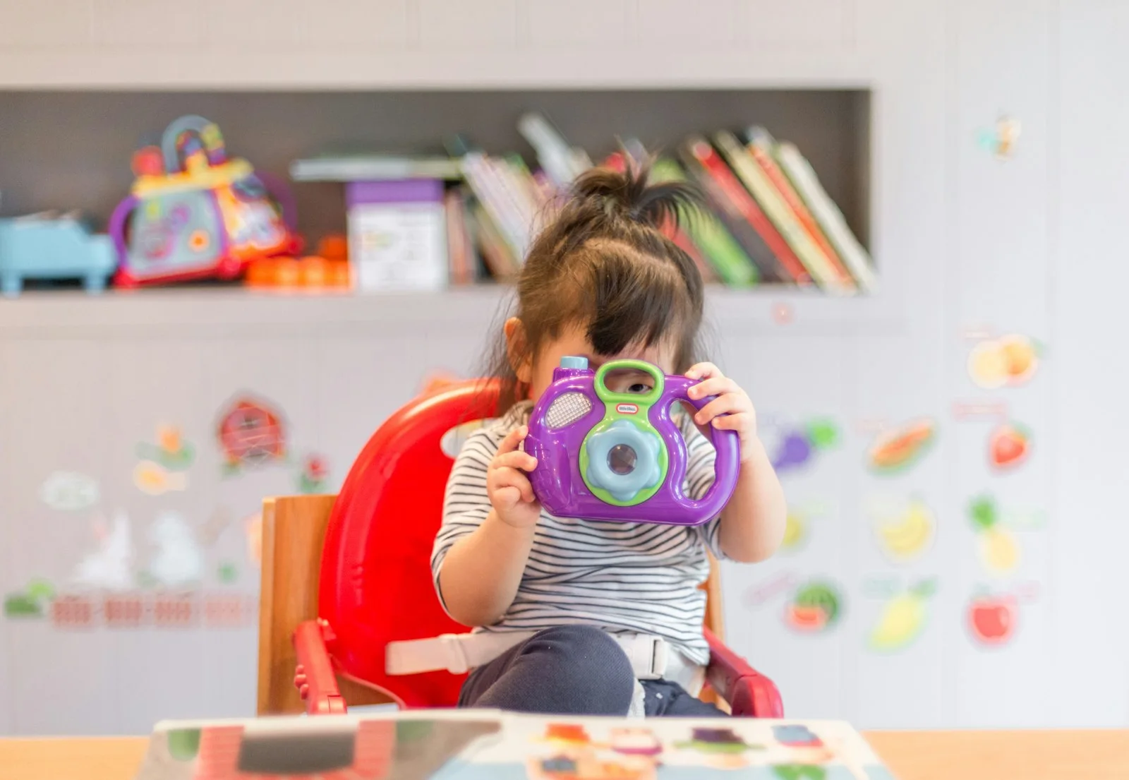 Parent holding a young child, illustrating early caregiver–child bonding