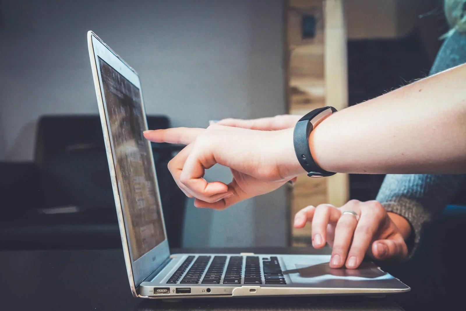 Person using a phone and laptop, suggesting ambiguous digital communication