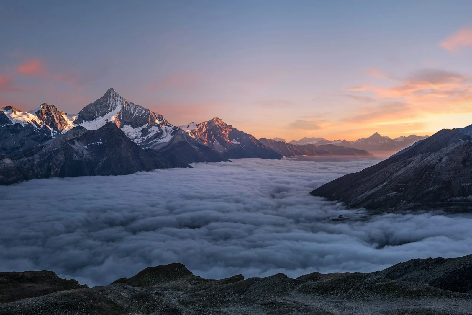 Person standing apart on a ridge, suggesting independence and emotional distance