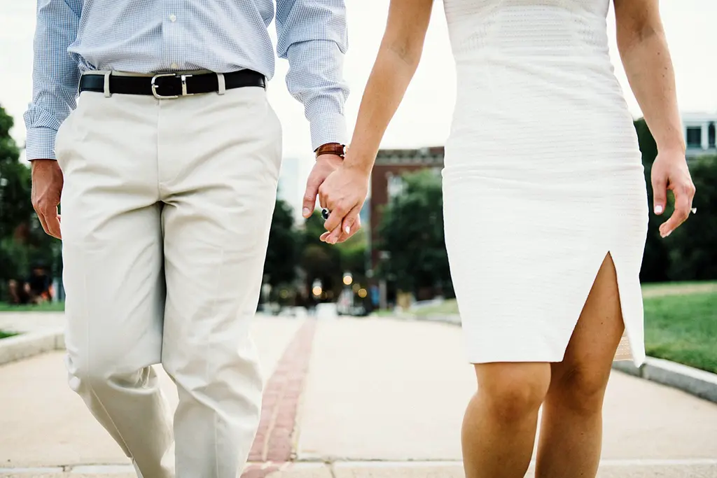 Couple holding hands, symbolizing connection and intimacy in relationships - representing secure attachment and emotional bonding